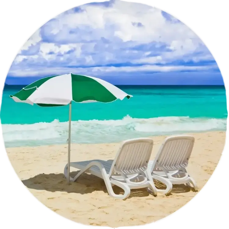 a beach of goa with a thatched umbrella and lounge chairs